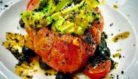 Vulkan-Tomaten, eine traditionelle Spezialität aus Granada, Spanien. Mit einer Avocado-Oliven-Mischung oben auf.